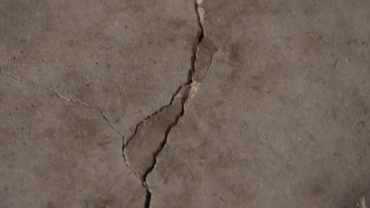 Garage slab: wide crack with a loose wedge of surface between two branches